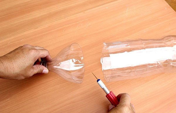 庭と果樹園のために手で持っているペットボトルの新しい工芸品